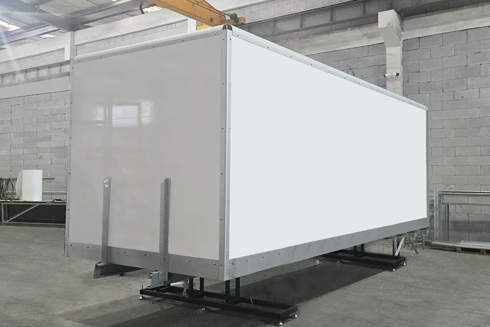 Refrigerated truck bodies lined up in the production bay